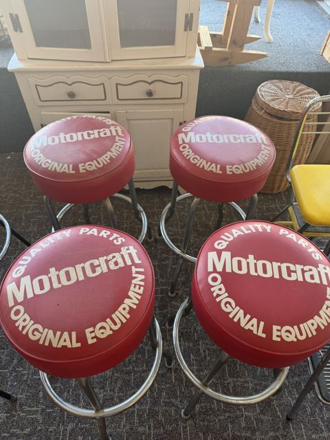 Four red Motorcraft Original Equipment bar stools