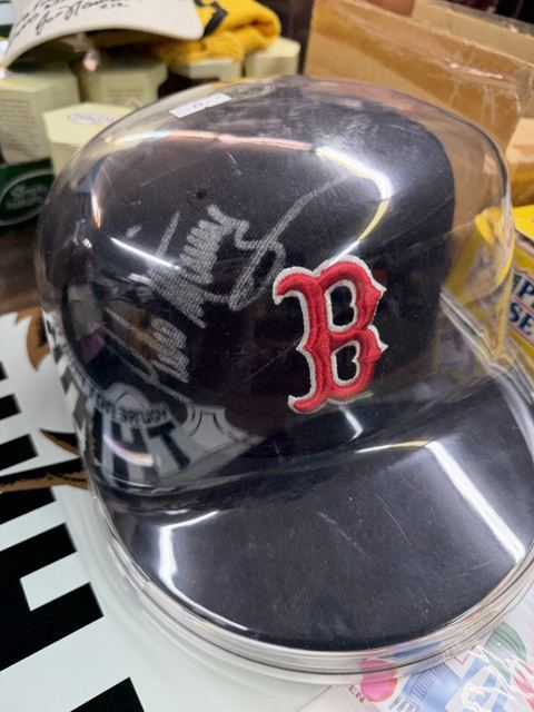 Signed Boston Red Sox cap in a display case
