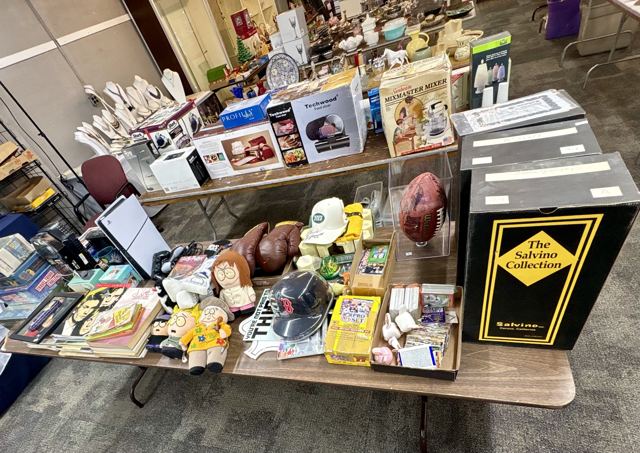 Sports memorabilia including a football, helmet, caps and boxing gloves