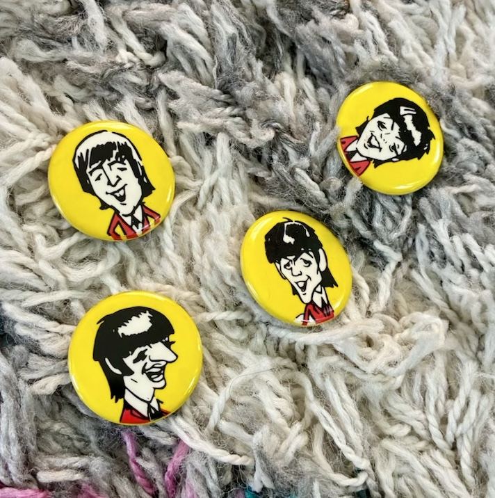 Set of four Beatles caricature pinback buttons