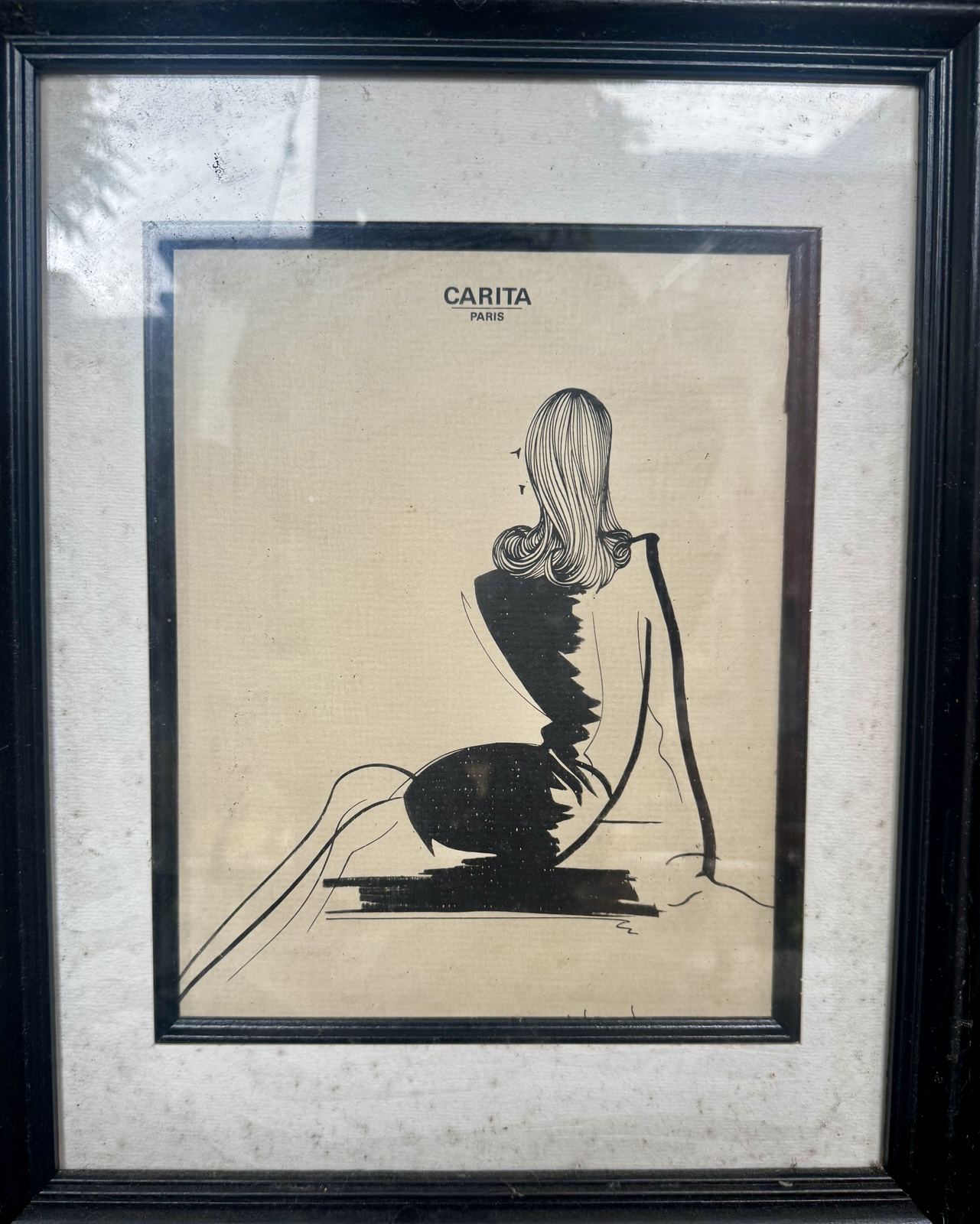 Framed Carita Paris fashion illustration, seated figure in profile