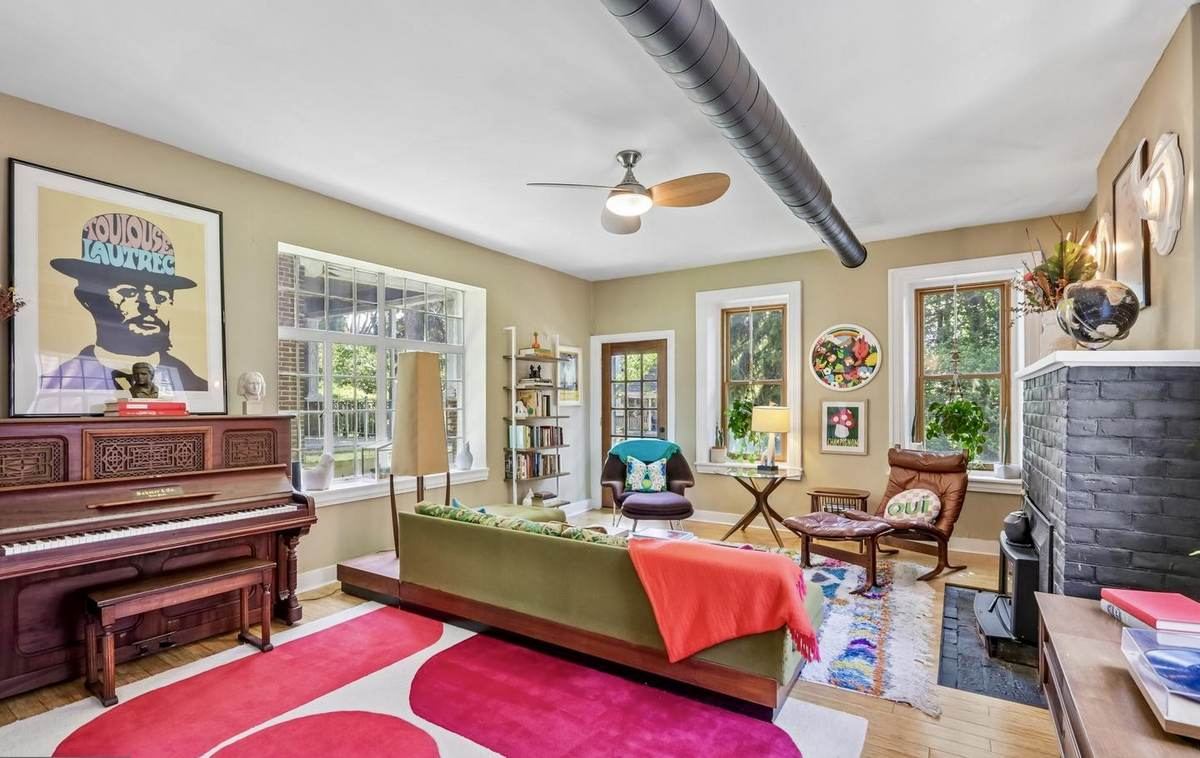 Colorful mid-century living room with piano and green sofa